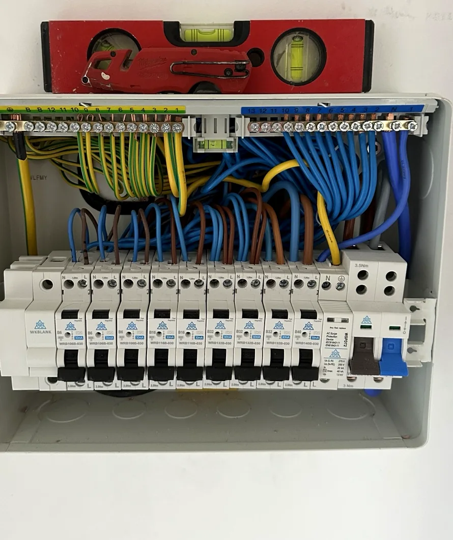 Consumer unit during installation with a spirit level above it